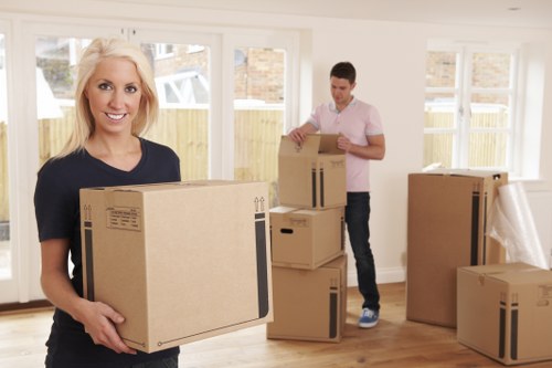 Team preparing moving boxes and equipment safely before a van job